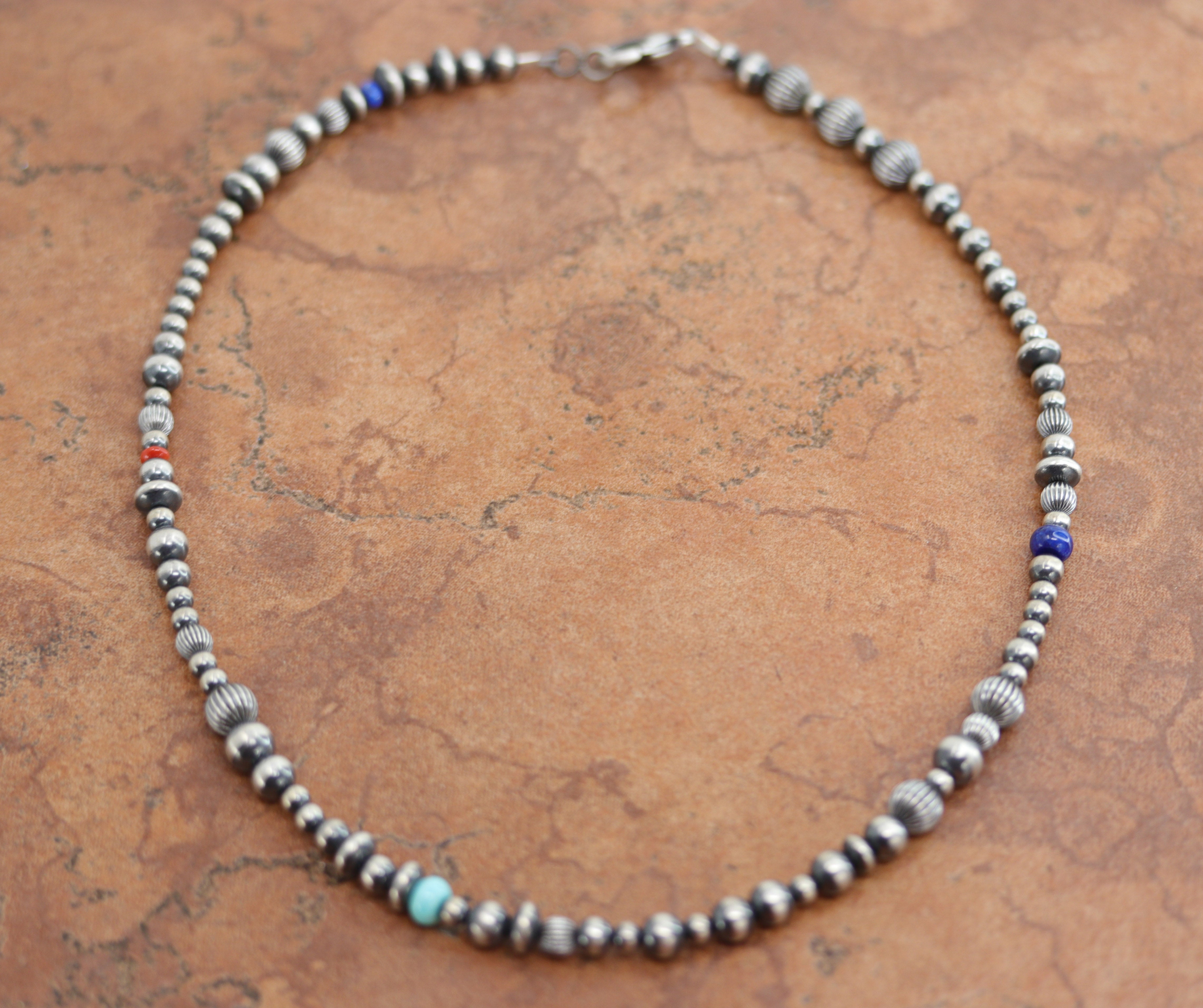 A beautiful silver Navajo Native American multi-stone necklace. The necklace is 18" in length and the beads measure 3/8". 
