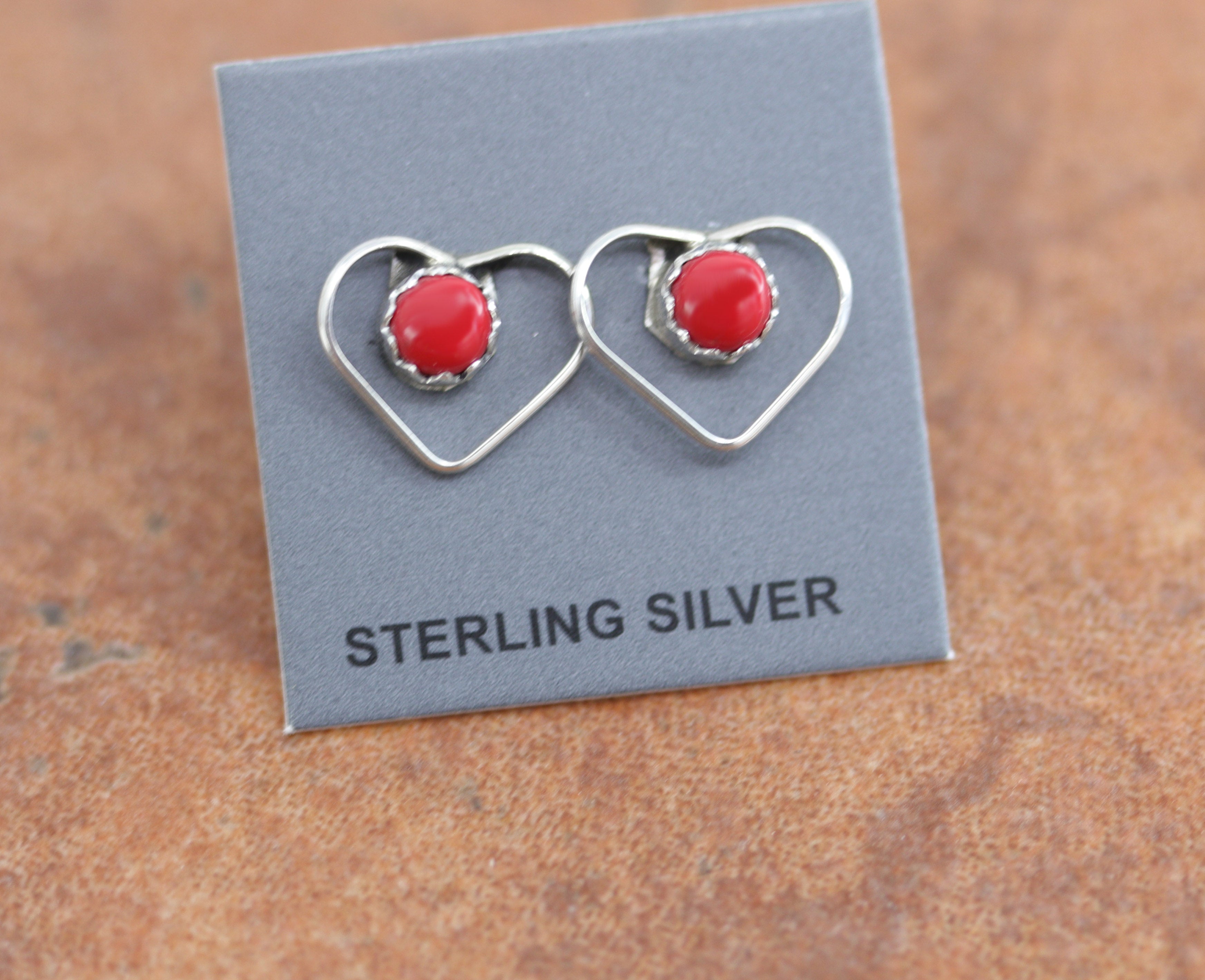 Beautiful Navajo sterling silver and coral heart earrings. The earrings are about 1/2" in length and 3/8" wide at the widest point. 