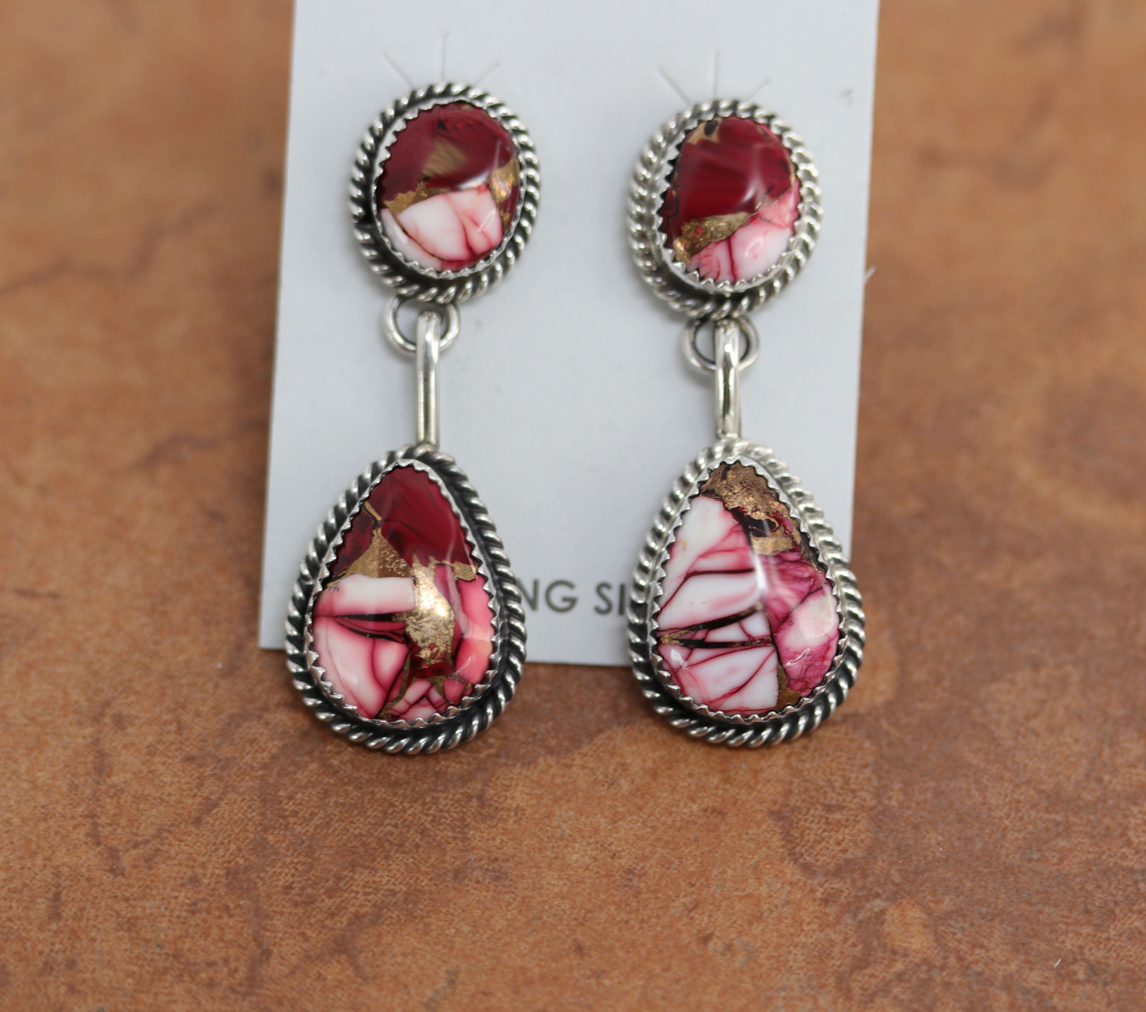 Navajo earrings. They are made from sterling silver and dahlia. Each earring is 2" in length and 3/4" in width. 