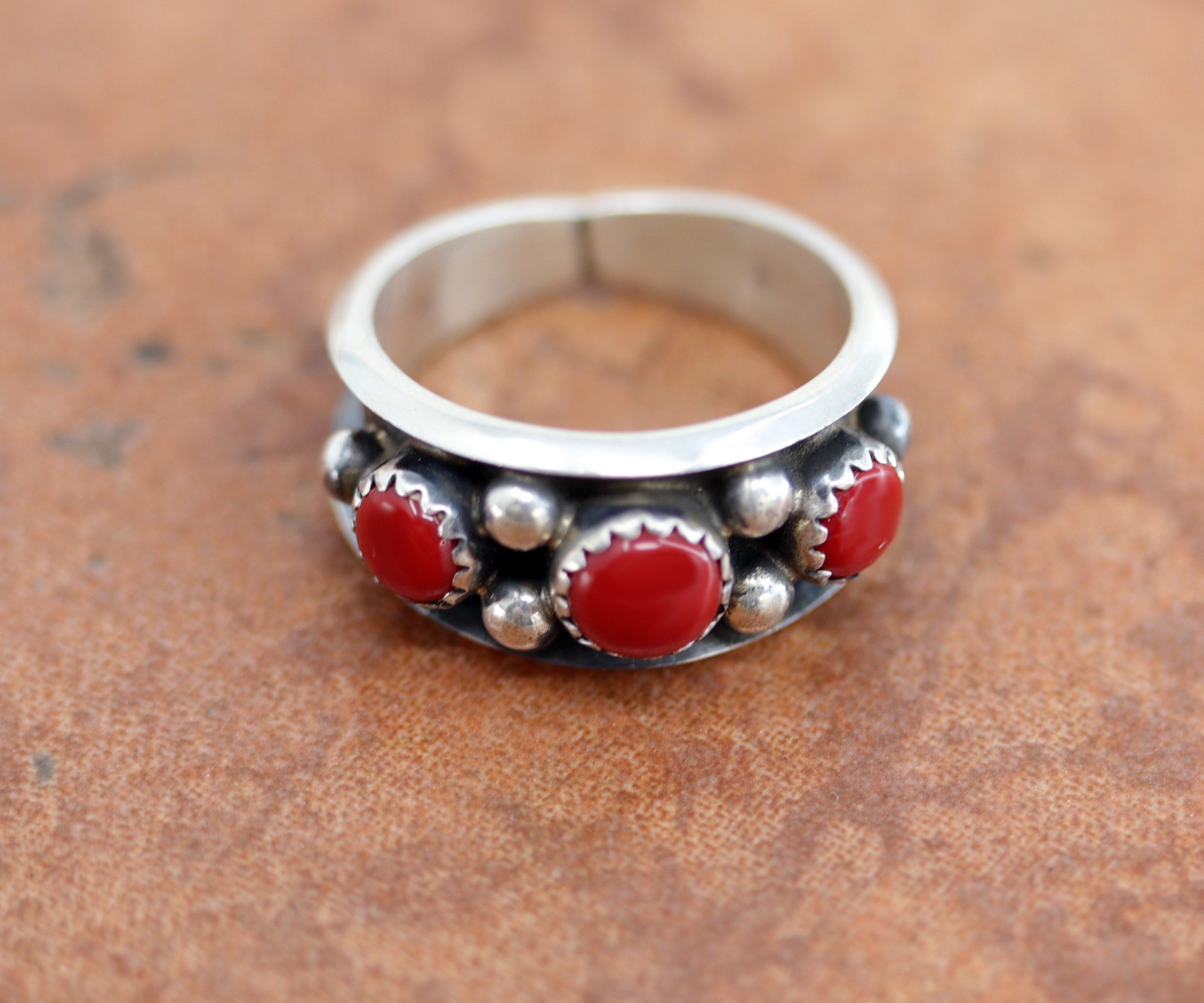 A lovely Navajo Native American ring. It is made from sterling silver and coral. The ring size 7 1/2 and it is 7/16" in length.