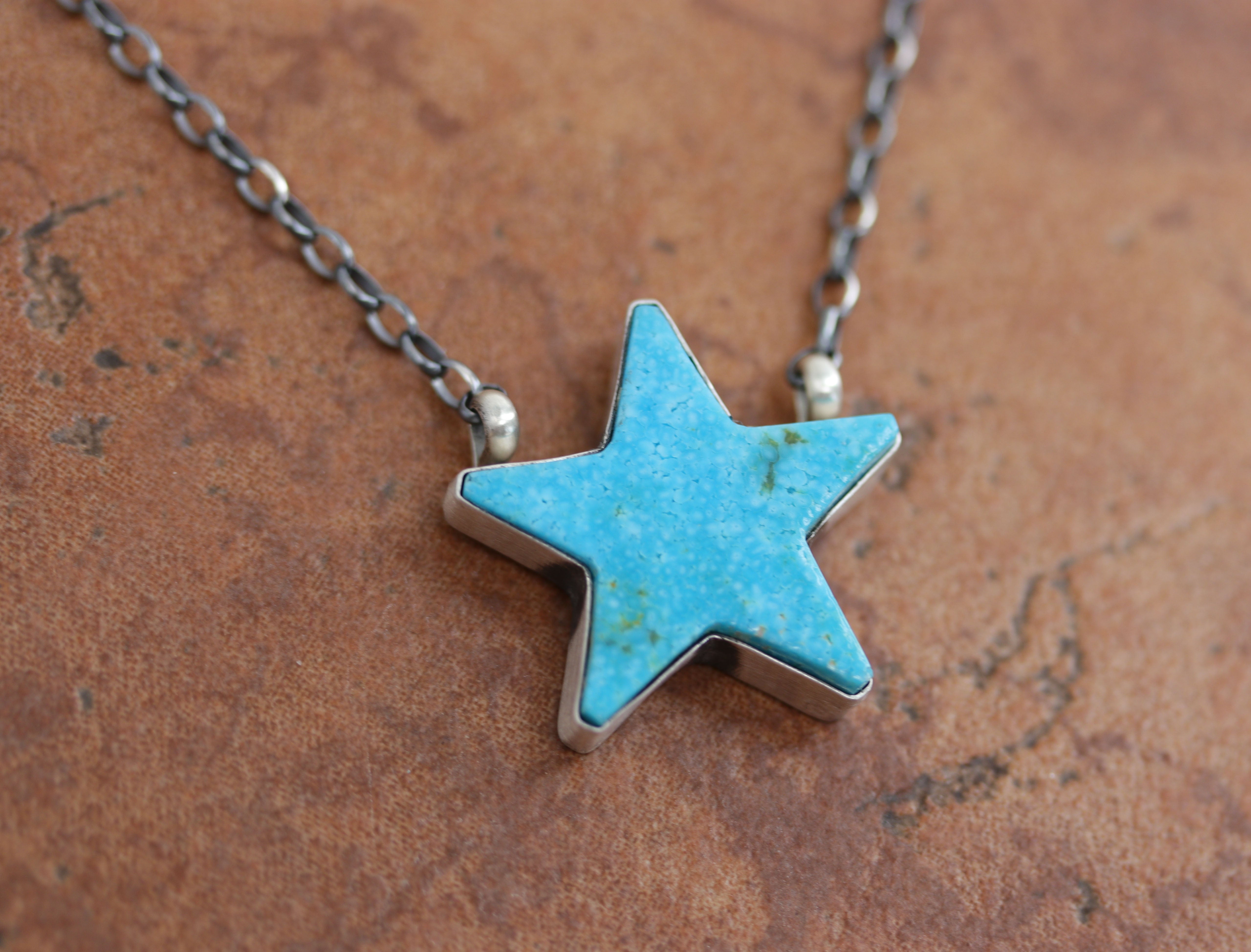 A beautiful Navajo Native American necklace. It is made from sterling silver and turquoise. The necklace is about 16" in length. The pendant measures 1".