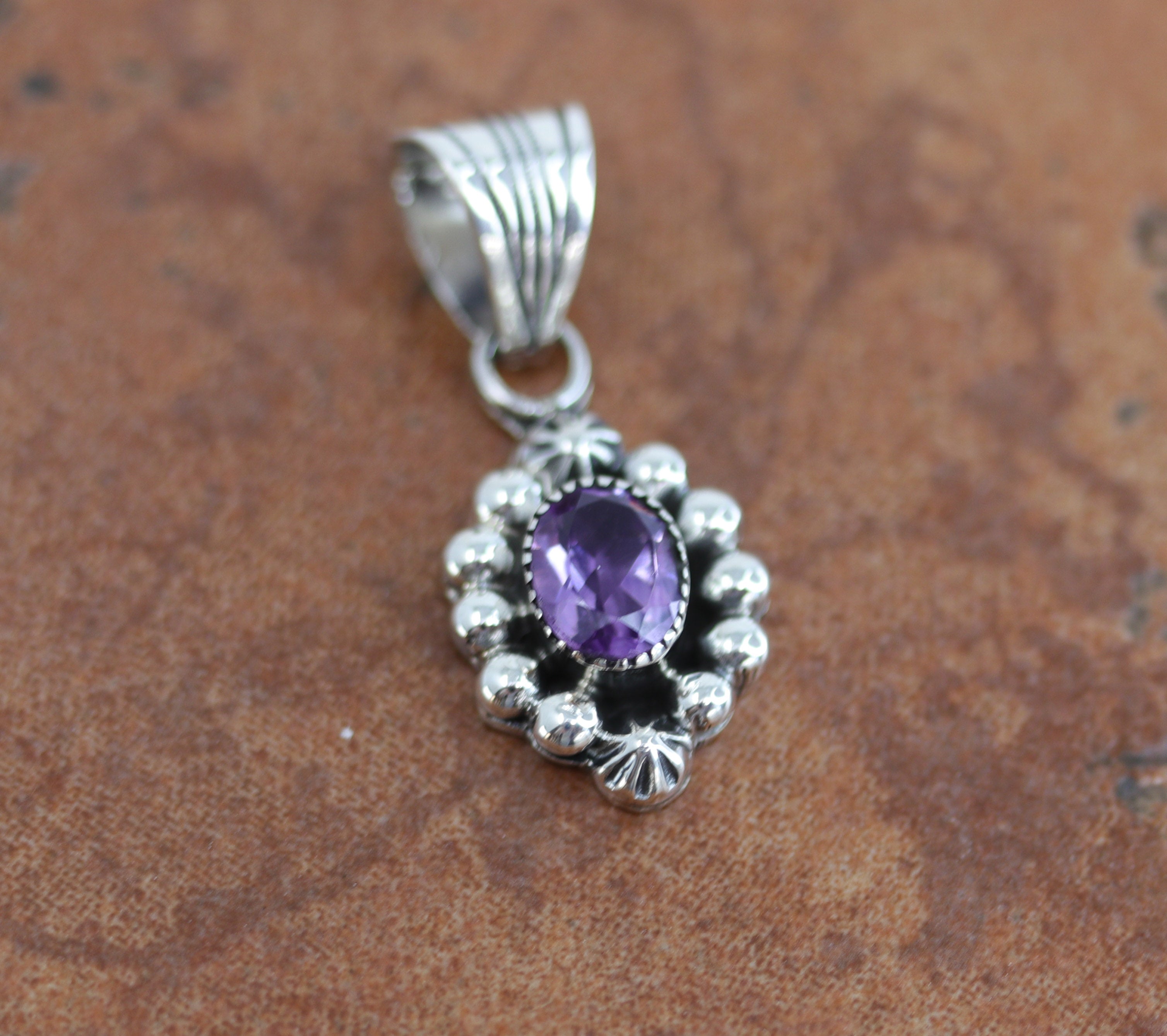 Navajo Native American Pendant by M Smith. It is made from sterling silver and amethyst. It is about 1 1/4" in length including the bail and 1/2" in width.