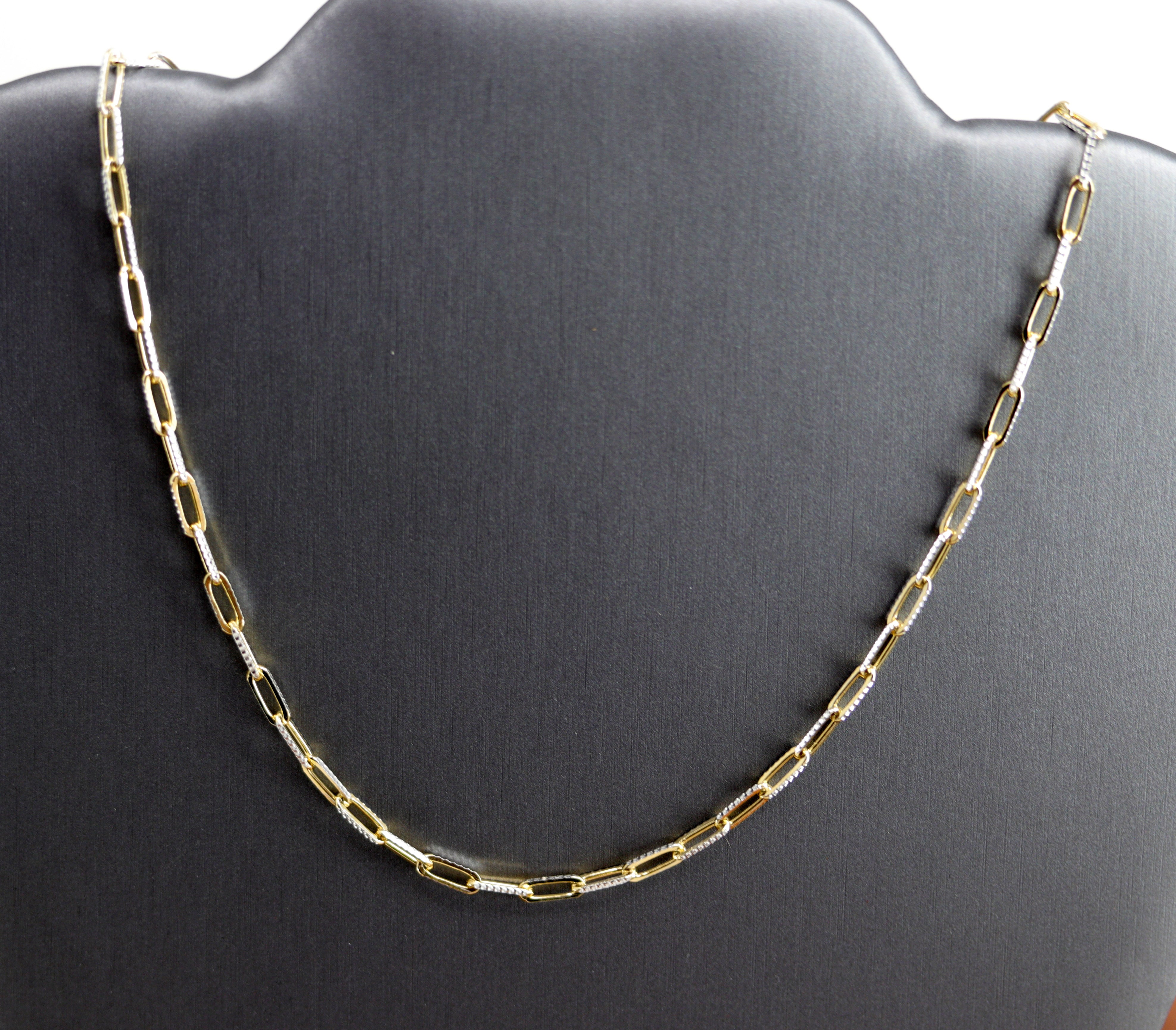A Beautiful Paper Clip Chain Link Necklace. It is made from .925 sterling silver and gold overlay. The length is about 16" and the width is 1/8". 