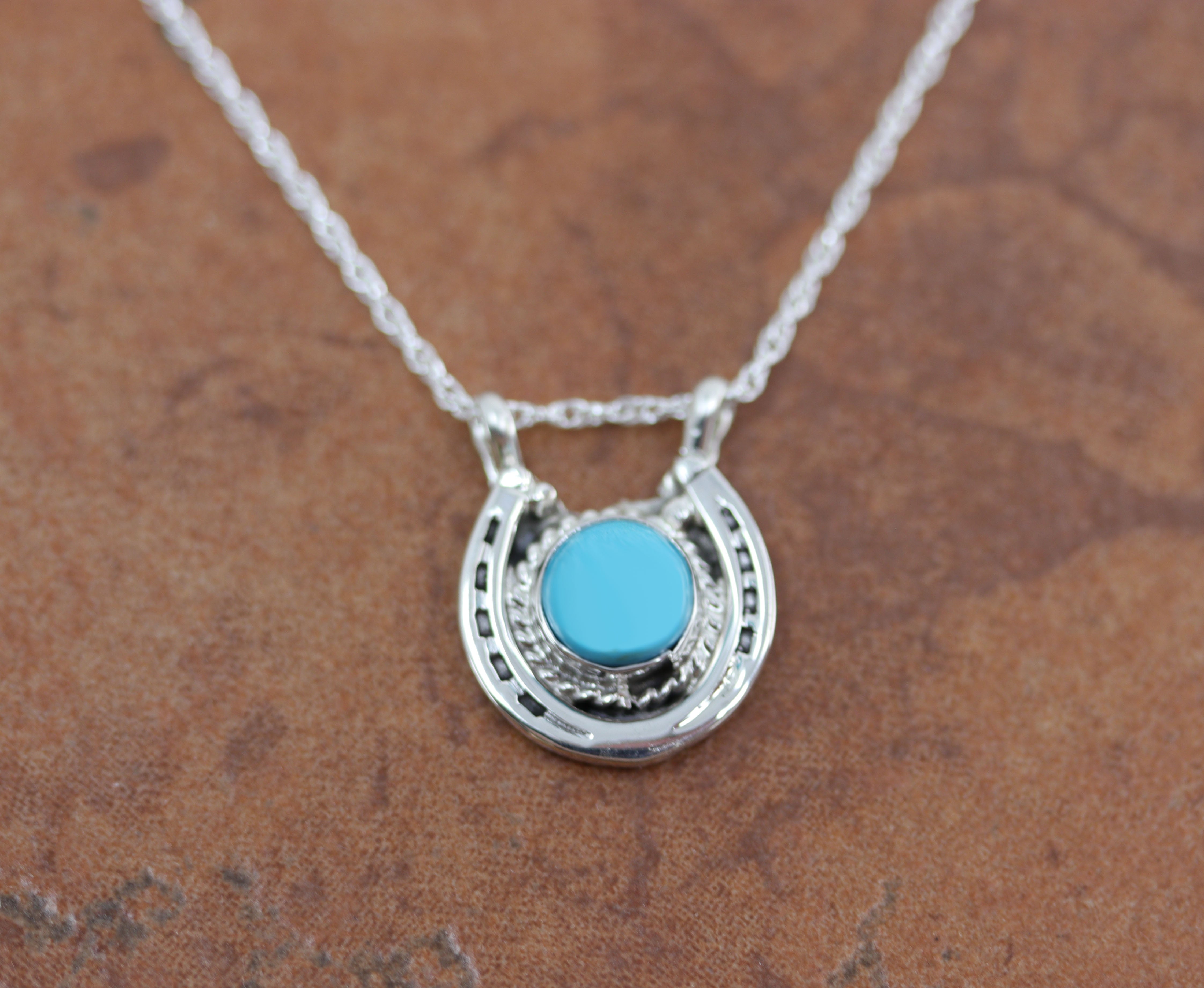 Lovely Navajo Native American Pendant. It is made from sterling silver and turquoise. It is 18" long and about 7/8" wide.