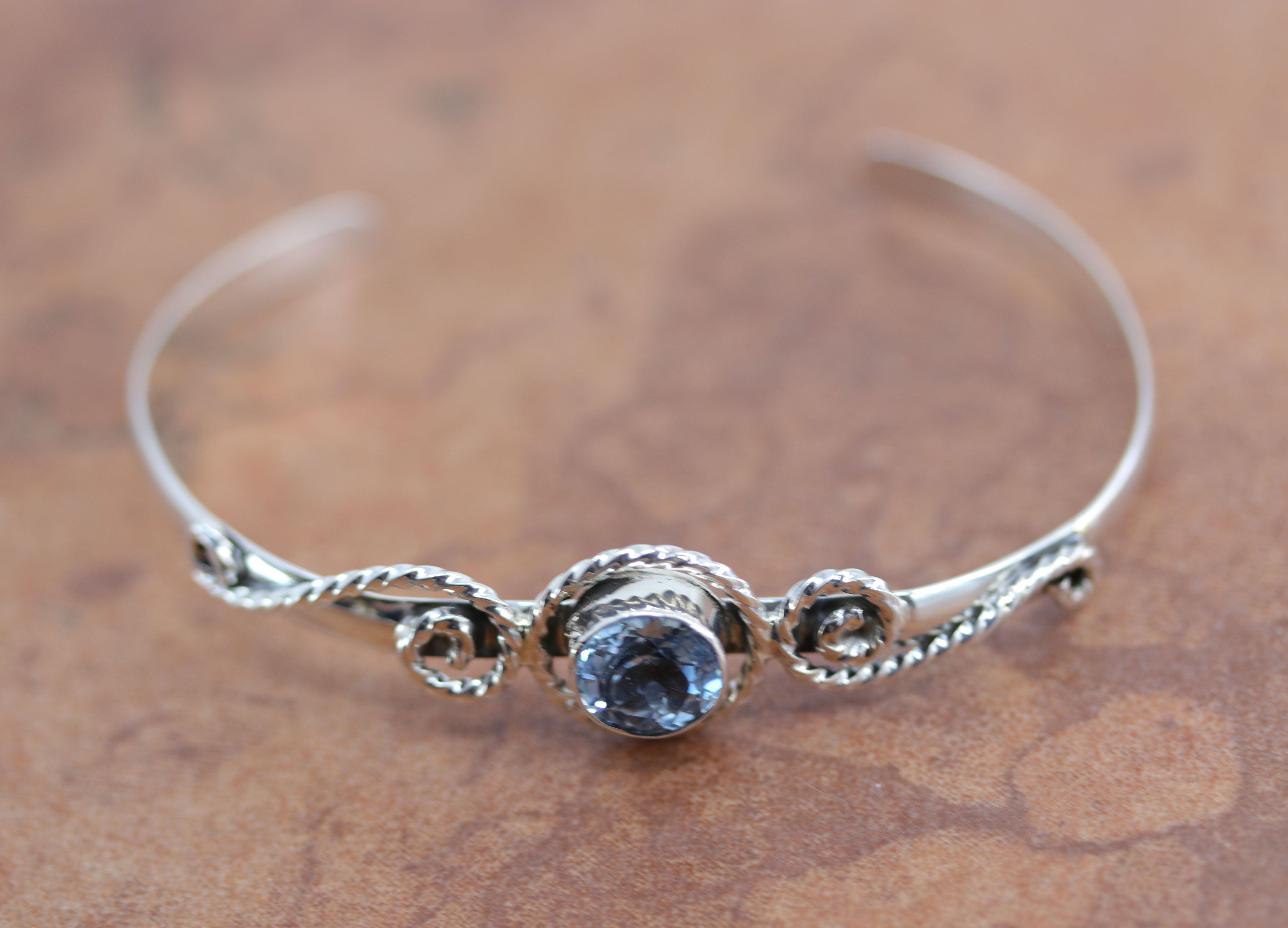 A Beautiful Navajo Native American bracelet. It is made from sterling silver and Aquamarine. It is about 6" around and about 5/8" wide at the widest point. The opening is about 1 1/4".