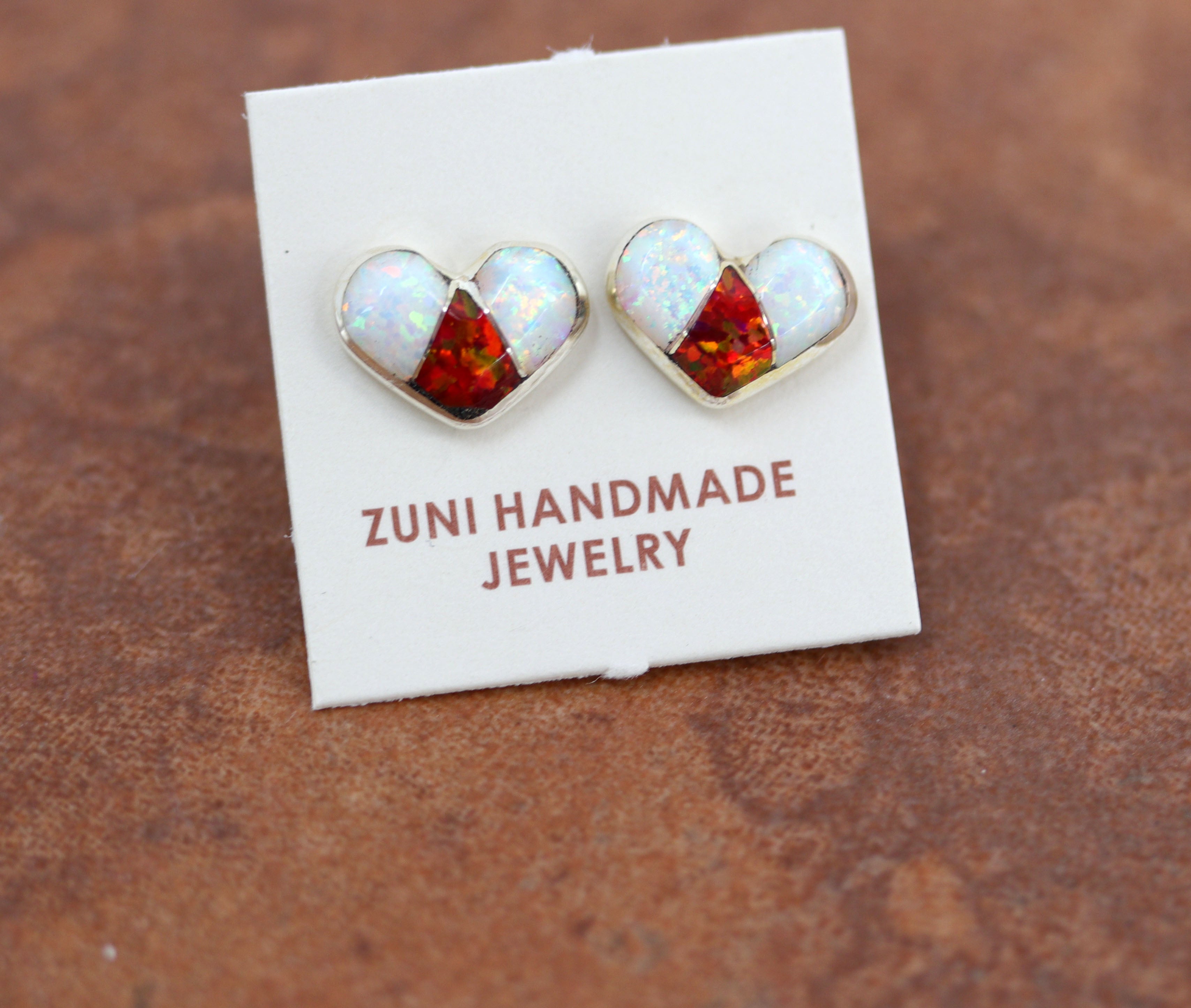 Beautiful Zuni Native American heart earrings. They are made from sterling silver and created opal. Each earring is 3/8" in length, and about 3/8" in width.