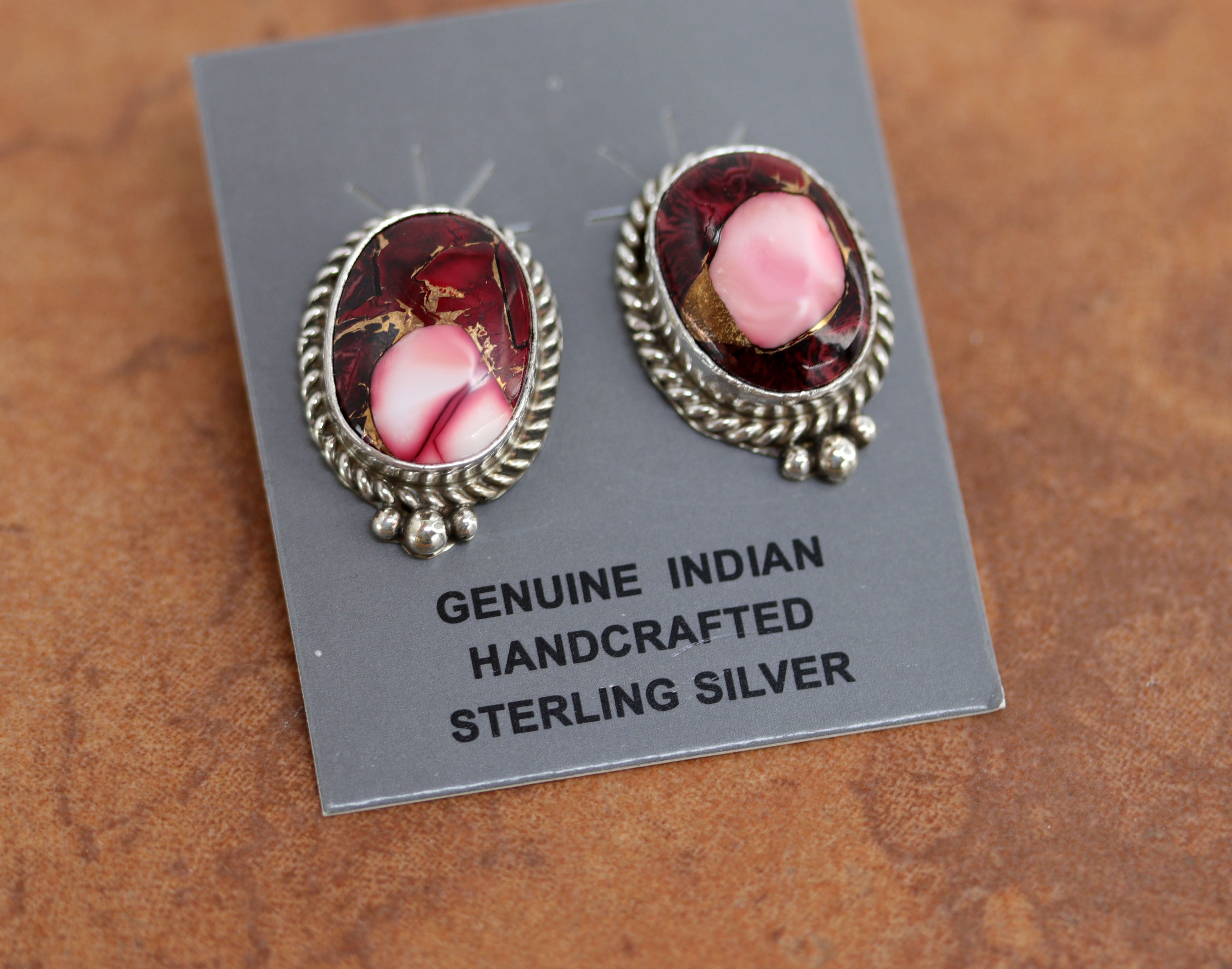 Navajo earrings. They are made from sterling silver and dahlia. Each earring is 1" in length and 3/4" in width.&nbsp;