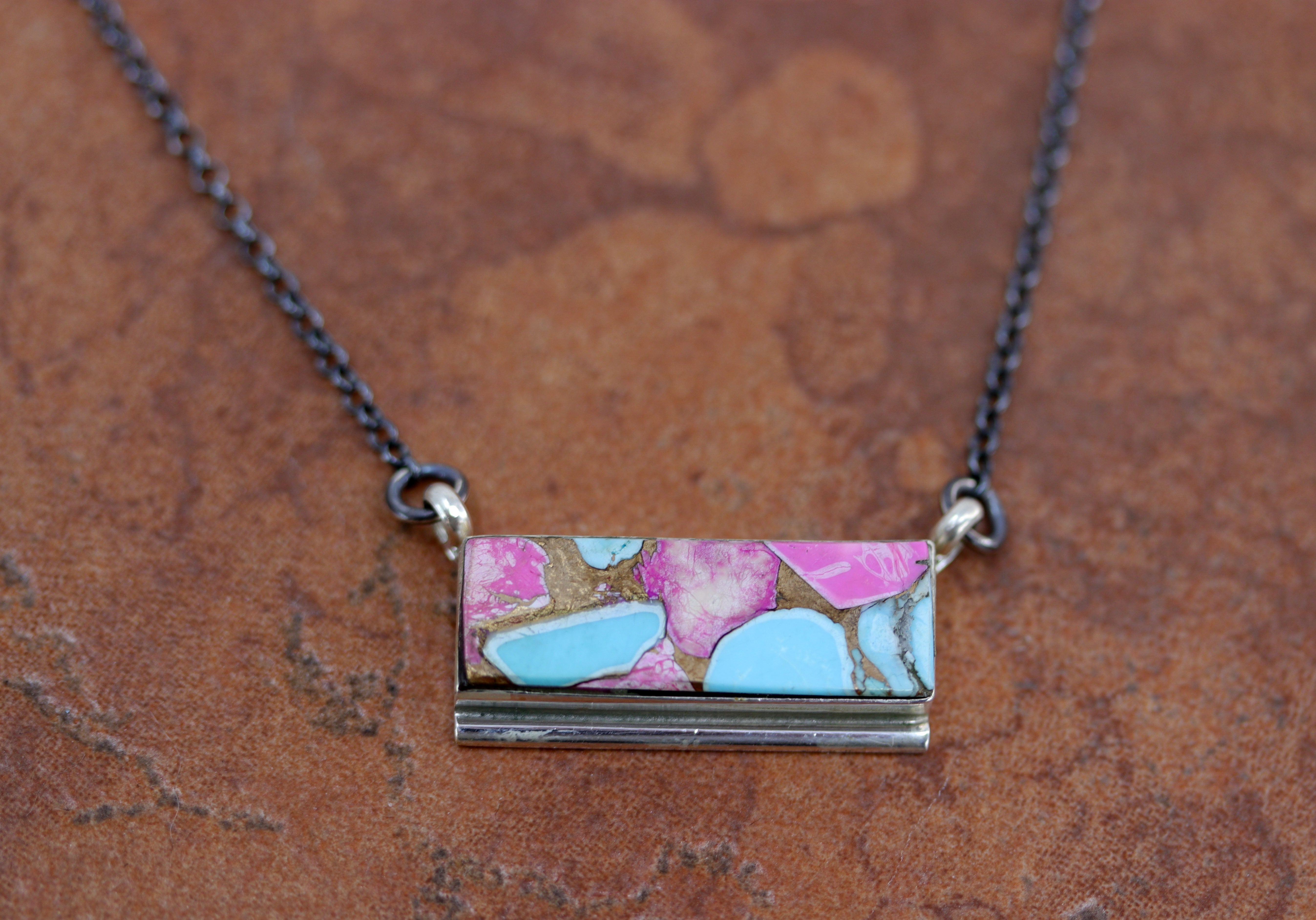 A beautiful Navajo Native American necklace. It is made from sterling silver, and cotton candy dahlia turquoise. The necklace is about 17" in length. The center pendant measures 1 1/8" by 5/8".