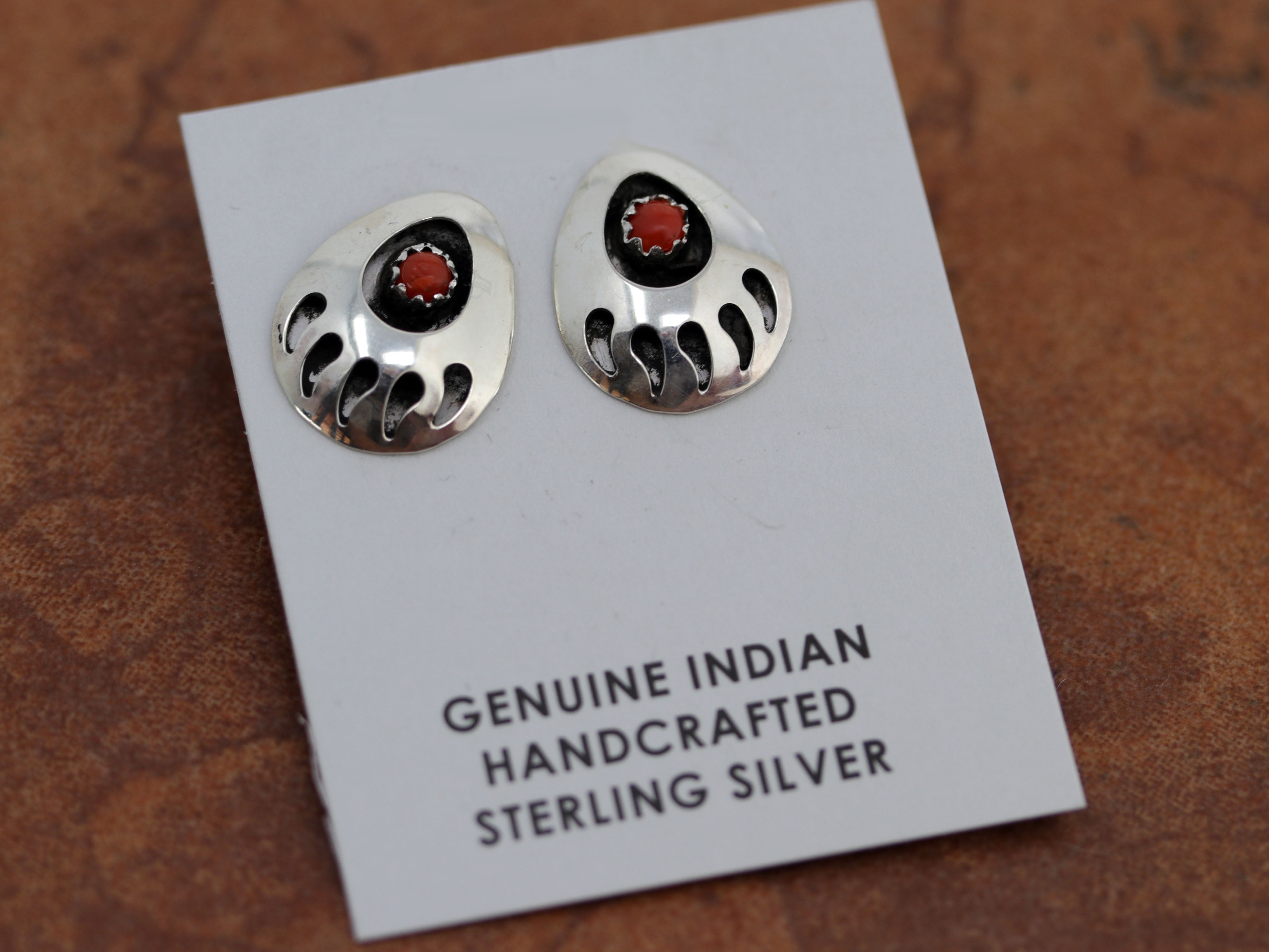 Native American earrings. They are made from sterling silver and coral. The earrings are about 3/4" in length and 1/2" wide.